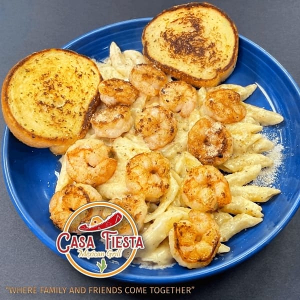 Casa Fiesta Mexican Grill's shrimp pasta with garlic bread on a blue plate.