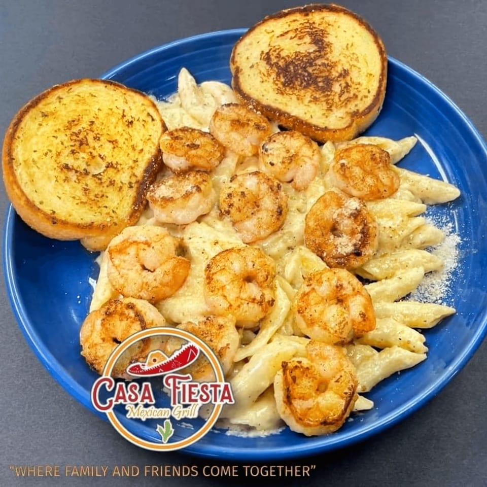 Casa Fiesta Mexican Grill's shrimp pasta with garlic bread on a blue plate.